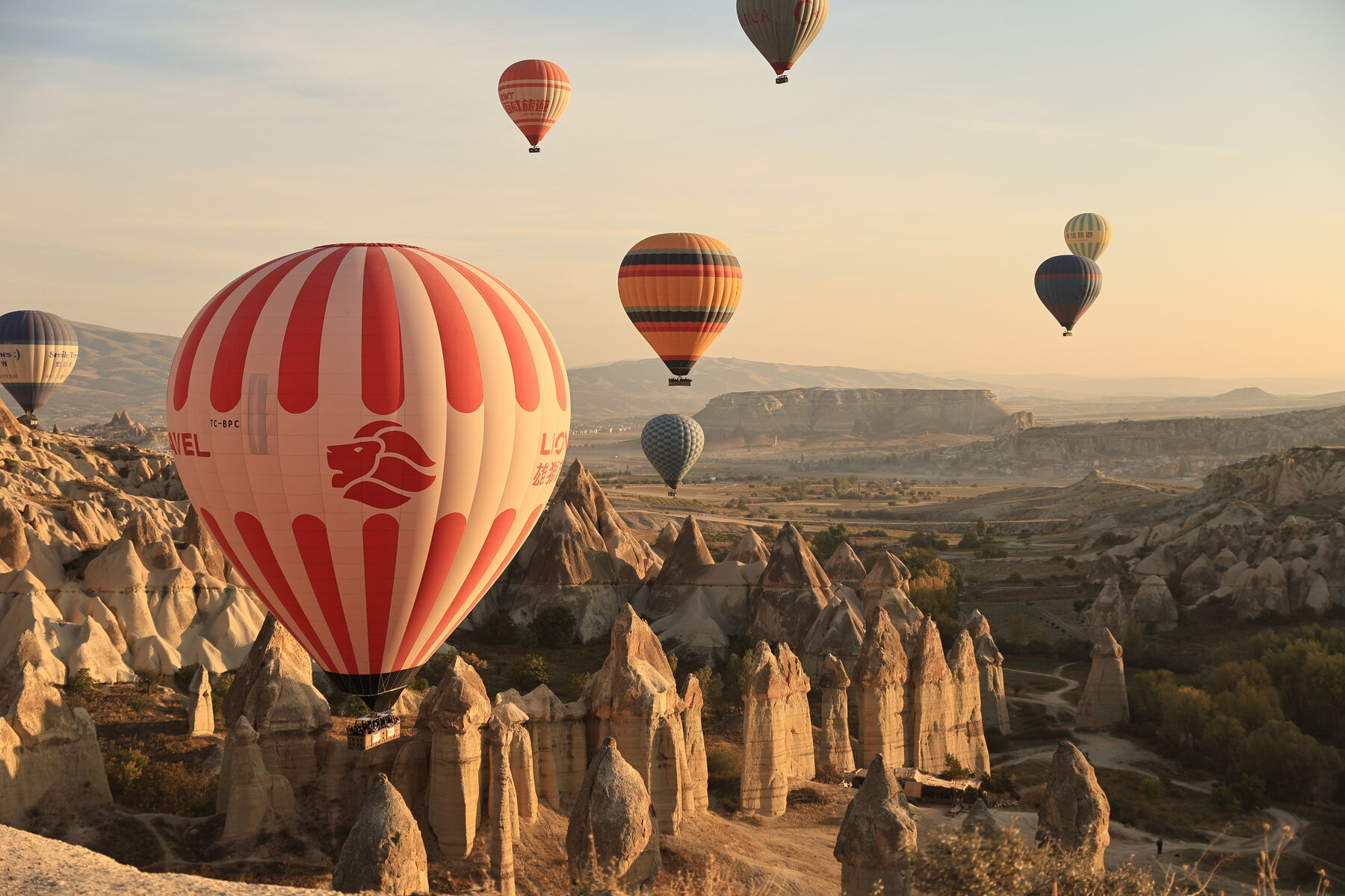 Hot air balloons over the fairy chimneys of Cappadocia at sunrise